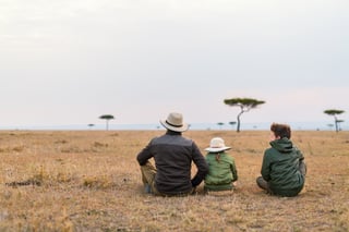 Family of Father and Kids on African Safari Vacation Enjoying Views Over Masai Mara in Kenya Family of Father and Kids on African Safari Vacation Enjoying Views Over Masai Mara in Kenya