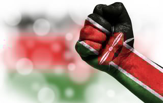 Flag of Kenya painted on male fist, strength,power,concept of conflict. On a blurred background with a good place for your text