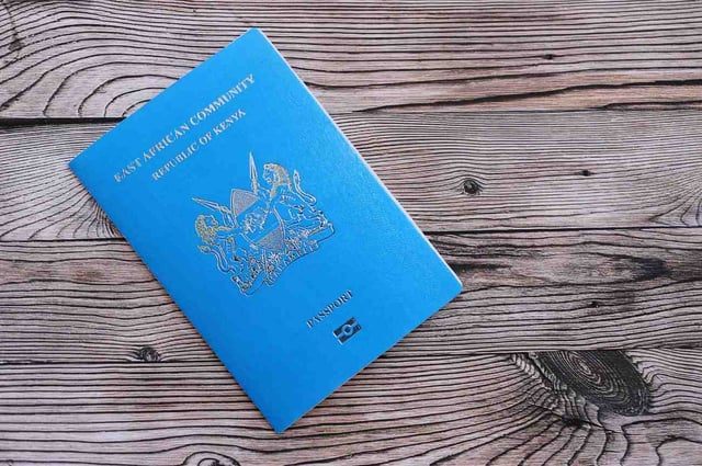 Passport Of Kenya Lying On A Wooden Surface