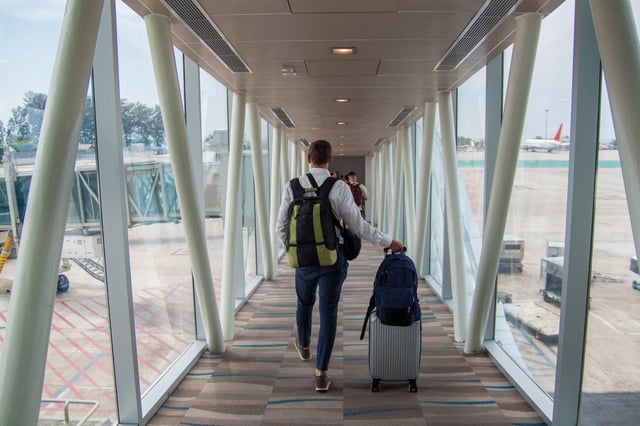 Traveller Walking In The Aeroplane Boarding Corridor