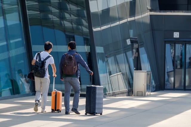 Travellers at the airport entrance